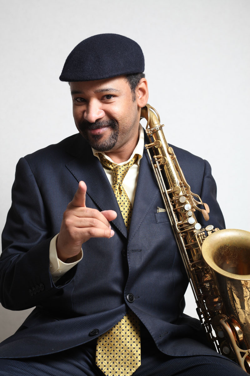 Tony Spruill smiling with saxophone